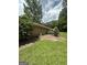 Secluded backyard featuring a stone edge and wooden deck offers a private, outdoor living space at 8440 Winston Way, Jonesboro, GA 30236