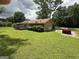 A red Corvette sits outside the traditional home with a garage and long, private driveway at 8440 Winston Way, Jonesboro, GA 30236