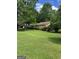 Traditional home set back from the street has mature trees enhancing its curb appeal at 8440 Winston Way, Jonesboro, GA 30236