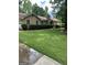 Charming single-story home features a well-manicured front yard and a classic brick chimney at 8440 Winston Way, Jonesboro, GA 30236