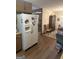 Cozy kitchen offering wood cabinets and a refrigerator, leading into the dining room at 8440 Winston Way, Jonesboro, GA 30236
