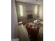 Living room featuring a brick fireplace, mantel, and large windows for natural light at 8440 Winston Way, Jonesboro, GA 30236