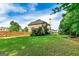 Large, green backyard is enclosed by a wooden fence, offering privacy and space for outdoor activities at 1605 Cascade Overlook, Peachtree City, GA 30269