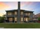 Spacious backyard featuring a patio, lush green lawn, and the back of the home with its many windows at 1605 Cascade Overlook, Peachtree City, GA 30269