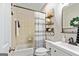 Cozy bathroom featuring tiled shower/tub, modern vanity, and decorative shelving for added charm at 1605 Cascade Overlook, Peachtree City, GA 30269
