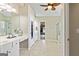 Bright primary bathroom features a double sink vanity, tile floor, and lots of storage at 1605 Cascade Overlook, Peachtree City, GA 30269