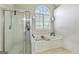 A clean bathroom features a shower and a soaking tub under a large window at 1605 Cascade Overlook, Peachtree City, GA 30269