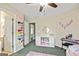 Bright bedroom featuring a ceiling fan, white storage shelves, a pink rug and walls adorned with decorations at 1605 Cascade Overlook, Peachtree City, GA 30269