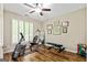 Bright exercise room featuring hardwood floors, exercise bike, weight bench, and abundant natural light at 1605 Cascade Overlook, Peachtree City, GA 30269