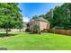 A large, well-maintained lawn and a view of the side of the brick house at 1605 Cascade Overlook, Peachtree City, GA 30269