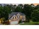Beautiful brick home featuring a well-maintained lawn, mature trees, and an attached garage at 1605 Cascade Overlook, Peachtree City, GA 30269