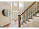 Grand foyer with hardwood floors, staircase, and ample natural light creates an inviting entry at 1605 Cascade Overlook, Peachtree City, GA 30269