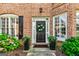 Inviting front door with sidelights, adorned with a wreath and potted plants at 1605 Cascade Overlook, Peachtree City, GA 30269