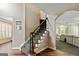 Hallway view featuring staircase and archway leading to the living room and dining areas at 1605 Cascade Overlook, Peachtree City, GA 30269