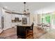 Open-concept kitchen featuring an island with barstool seating, stainless appliances, and a view into the dining area at 1605 Cascade Overlook, Peachtree City, GA 30269