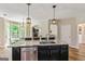 Kitchen island with stainless dishwasher, undermount sink, granite countertop, and seating overlooking breakfast room at 1605 Cascade Overlook, Peachtree City, GA 30269
