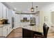 Kitchen features white cabinets, stainless appliances, granite countertops, kitchen island with bar seating, and access to breakfast nook at 1605 Cascade Overlook, Peachtree City, GA 30269
