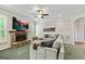 Relaxing living room featuring a stone fireplace, large television, and comfortable seating arrangement at 1605 Cascade Overlook, Peachtree City, GA 30269