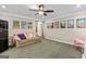 Living room with carpet, vintage-style posters, and a comfortable leather couch at 1605 Cascade Overlook, Peachtree City, GA 30269