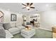 Comfortable living room featuring a stone fireplace, large sofa, and open archways to other areas at 1605 Cascade Overlook, Peachtree City, GA 30269
