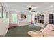 Spacious living room with a ceiling fan, plush seating, TV, and custom shelving with decorative items and toys at 1605 Cascade Overlook, Peachtree City, GA 30269