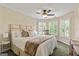 Inviting main bedroom with bright windows, plush bedding, and a neutral color palette at 1605 Cascade Overlook, Peachtree City, GA 30269