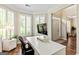 Well-lit home office with a modern desk, ergonomic chair, and large windows with plantation shutters at 1605 Cascade Overlook, Peachtree City, GA 30269