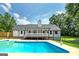 Home exterior showcasing a lovely pool, spacious backyard, and inviting covered deck at 858 Pates Creek Rd, Stockbridge, GA 30281