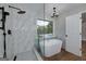 Bathroom featuring a soaking tub, walk in shower and a view of the pool at 858 Pates Creek Rd, Stockbridge, GA 30281