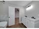 Modern bathroom boasts double sinks and a bathtub, with a view to the bedroom at 858 Pates Creek Rd, Stockbridge, GA 30281