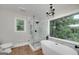 Modern bathroom with a frameless glass shower and a freestanding bathtub at 858 Pates Creek Rd, Stockbridge, GA 30281