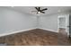 The bedroom features hardwood floors, a ceiling fan and baseboard trim at 858 Pates Creek Rd, Stockbridge, GA 30281