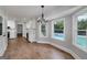 Dining area with hardwood floors, bright windows overlooking the pool, and a modern chandelier at 858 Pates Creek Rd, Stockbridge, GA 30281