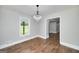 Bright dining room featuring hardwood floors and a modern chandelier at 858 Pates Creek Rd, Stockbridge, GA 30281