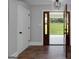 Entryway featuring beautiful hardwood floors, a stylish light fixture, and a view to the front porch at 858 Pates Creek Rd, Stockbridge, GA 30281