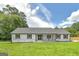 Charming ranch-style home with white siding, a covered front porch, and a well-manicured lawn at 858 Pates Creek Rd, Stockbridge, GA 30281