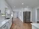 Modern kitchen featuring white cabinets, stainless steel appliances, and hardwood floors at 858 Pates Creek Rd, Stockbridge, GA 30281