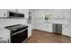 Updated kitchen with white cabinets, quartz countertops, and stainless steel appliances at 858 Pates Creek Rd, Stockbridge, GA 30281