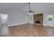 Bright living room with a stone fireplace, hardwood floors, and a view of the backyard at 858 Pates Creek Rd, Stockbridge, GA 30281