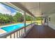 Inviting covered deck overlooking a refreshing blue swimming pool and lush, fenced backyard at 858 Pates Creek Rd, Stockbridge, GA 30281