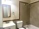 Tiled bathroom featuring a tub-shower, a commode, and a vanity with a white sink at 341 Pineland Sw Rd, Mableton, GA 30126
