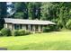 Charming brick home with mature landscaping and an attached carport at 341 Pineland Sw Rd, Mableton, GA 30126