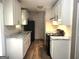 Bright kitchen featuring white cabinets, granite counters and black appliances at 341 Pineland Sw Rd, Mableton, GA 30126