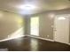 Living room featuring hardwood floors, a window, and a white door at 341 Pineland Sw Rd, Mableton, GA 30126