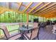Outdoor dining area featuring a glass-topped table and comfortable seating under a covered porch at 107 Trisha Ln, Grantville, GA 30220
