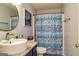 Bathroom featuring stylish vessel sink, granite countertop, and a blue floral shower curtain at 107 Trisha Ln, Grantville, GA 30220