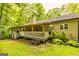 Back of house featuring a porch with a deck and stairs leading to the backyard at 107 Trisha Ln, Grantville, GA 30220