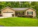 Charming single-story home with a well-maintained lawn, attached garage, and flowering bushes at 107 Trisha Ln, Grantville, GA 30220
