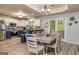 Open kitchen and dining area with white cabinets, a breakfast bar, and stainless steel appliances at 107 Trisha Ln, Grantville, GA 30220