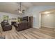 Spacious living room with a ceiling fan, fireplace, LVP flooring, and large windows at 107 Trisha Ln, Grantville, GA 30220